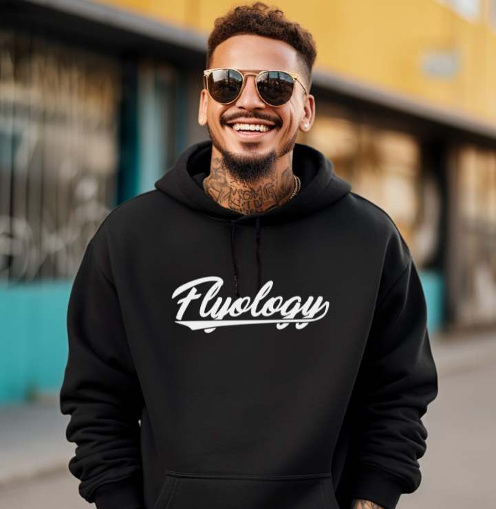 Man wearing a black hoodie with 'Flyology' logo in an urban setting
